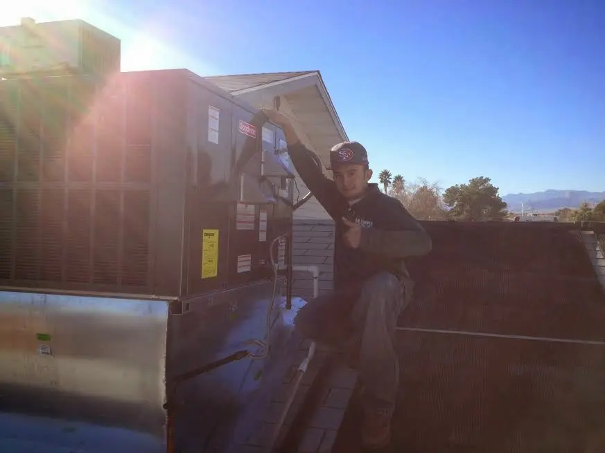 HVAC technician performing HVAC Inspection on a rooftop unit in Mint Hill